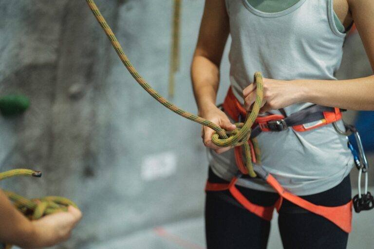 crop climber tying safety rope during training
