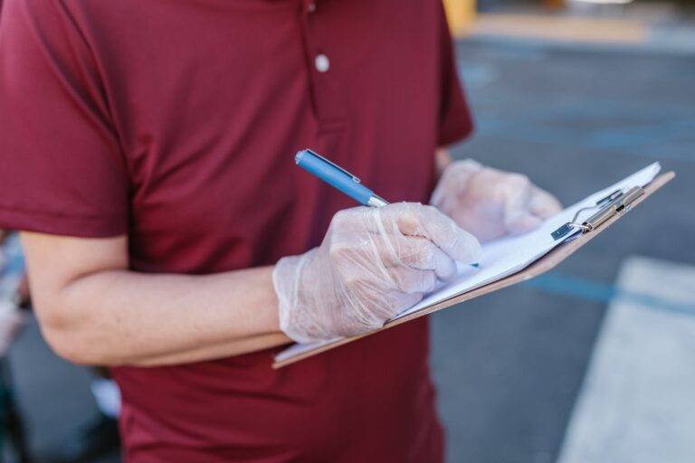 a person in maroon shirt taking notes