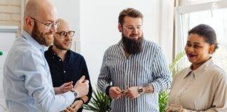 men looking at a woman holding cash at an office