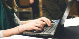 woman typing on laptop