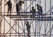 workers on scaffolding at construction site