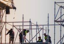 workers on scaffolding at construction site
