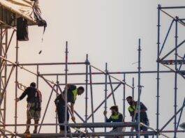 workers on scaffolding at construction site
