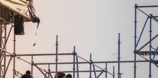 workers on scaffolding at construction site
