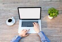 person s hand on laptop