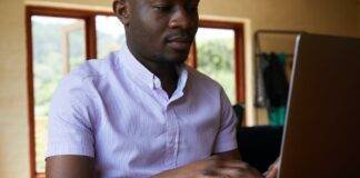 black man chatting on internet in laptop
