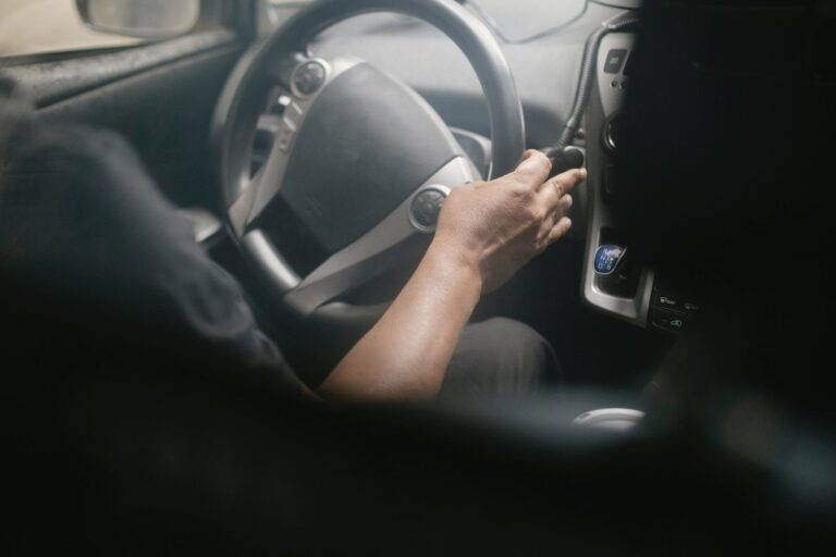 crop driver turning steering wheel in car