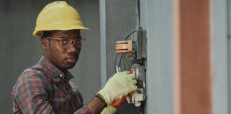 an electrician repairing a fuse box