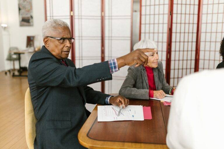man in suit sitting in meeting at office