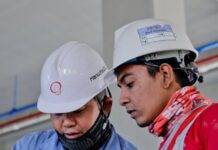 two man holding white paper