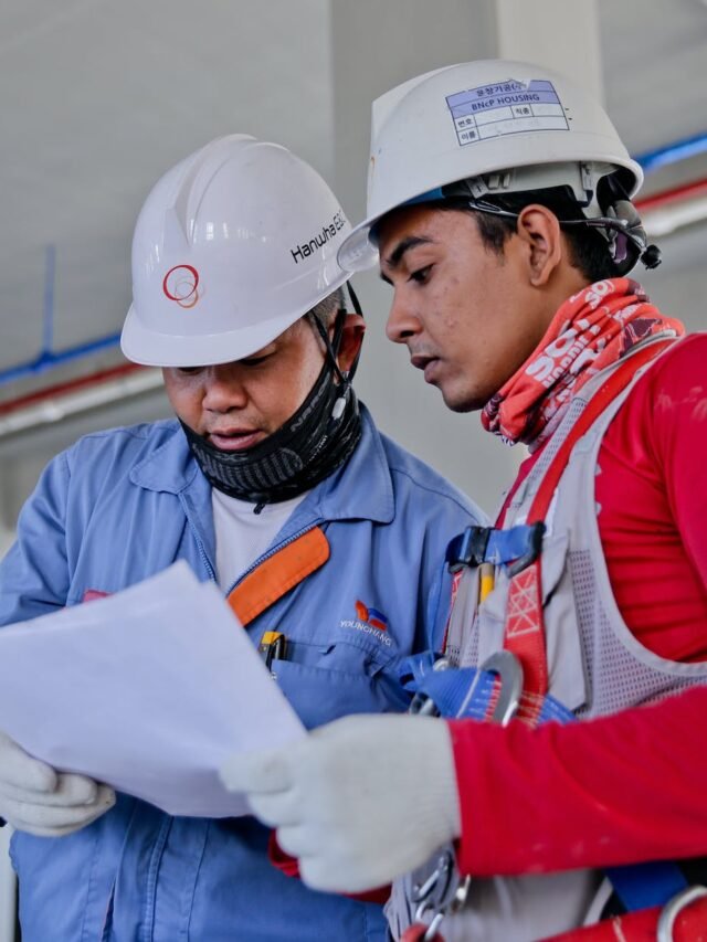 two man holding white paper