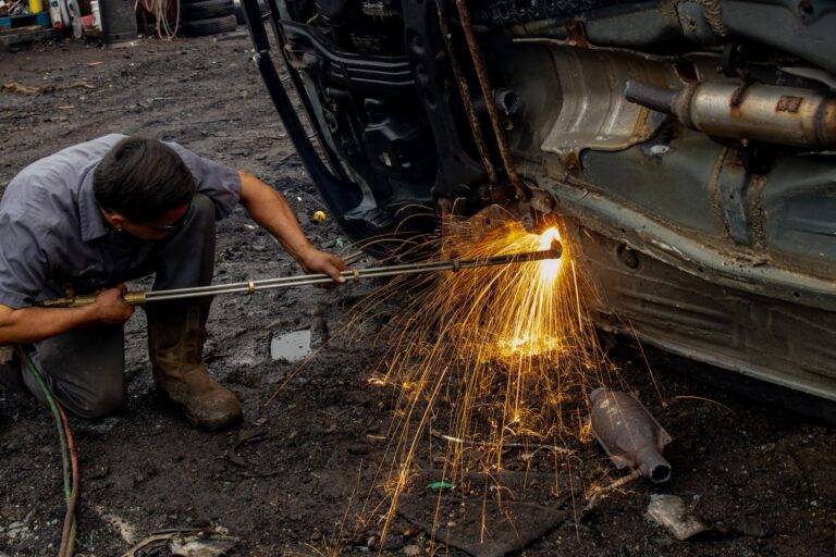 man welding car