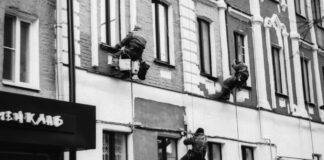 construction workers painting a building