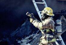 firefighter holding water hose