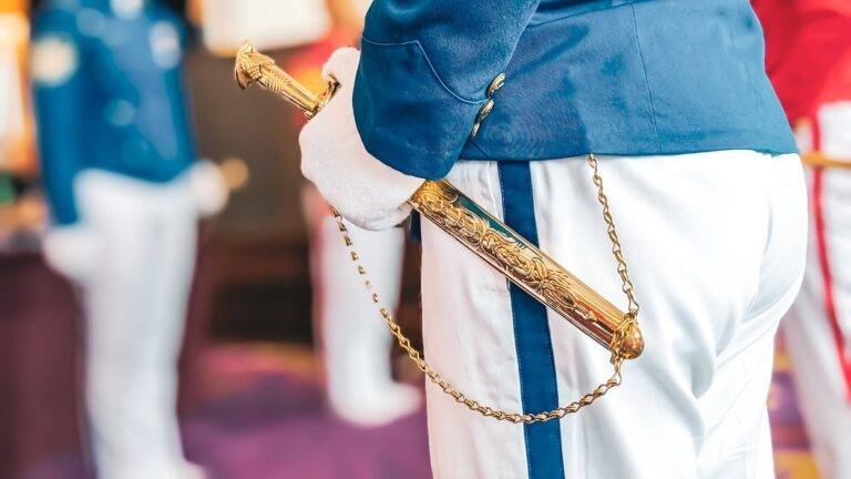 selective focus of young cadet s hand holding the decorative stainless steel ponyard sword with golden coated eagle head on a ceremony vocational academy and patriotism concept