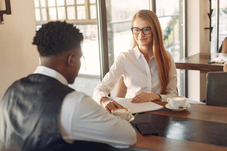 man being interviewed by a woman