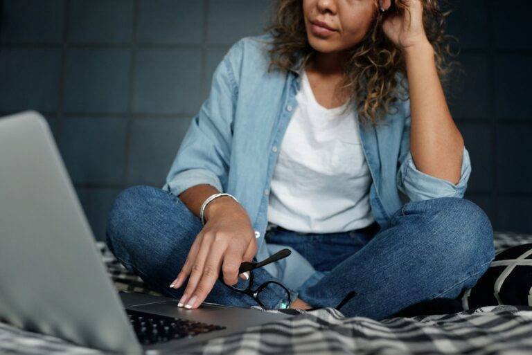 photo of woman sitting on bed