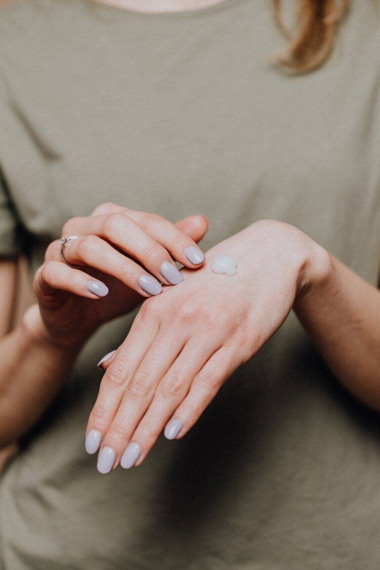 crop woman with moisturizer on hands