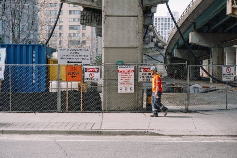 worker in uniform walking along street