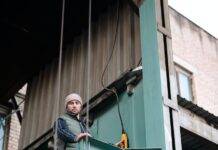 a man in winter jacket working in a warehouse