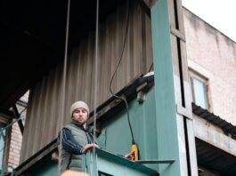 a man in winter jacket working in a warehouse