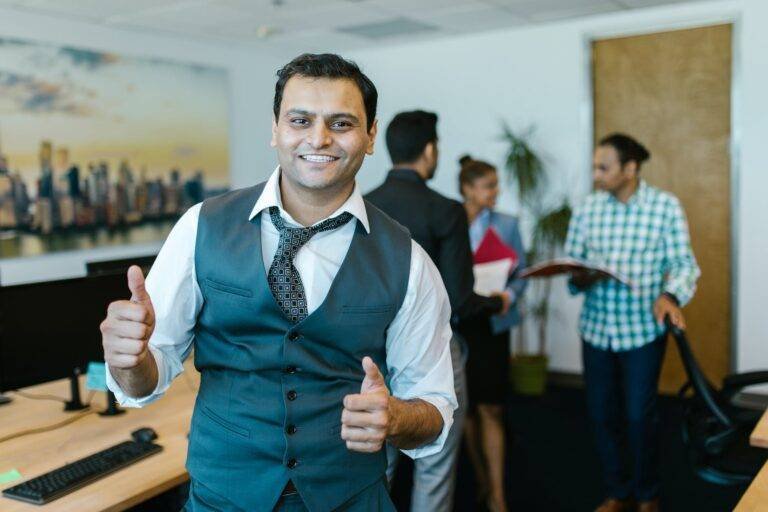 man wearing a waistcoat doing a thumbs up sign