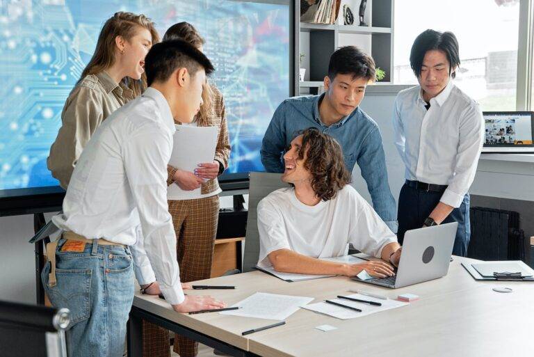 employees looking at the screen of the laptop