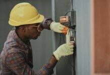 an electrician repairing a fuse box