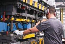 worker with hearing protection in factory