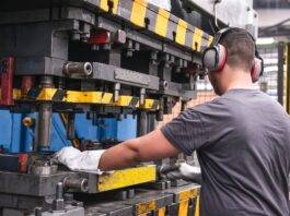 worker with hearing protection in factory