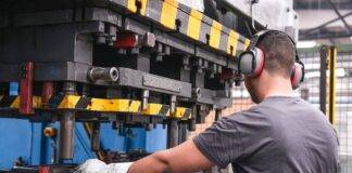 worker with hearing protection in factory