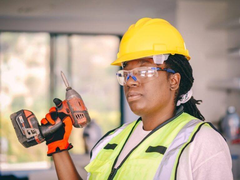 handywoman holding a hand drill