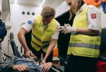 paramedics using a defibrillator on a patient