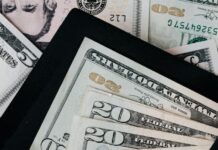 set of black opened envelope and cash dollars