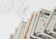 different dollar bills on marble surface