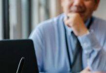 woman filling job application form in office with boss