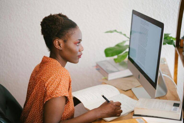 photo of woman looking on computer