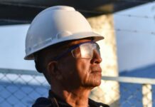 man in safety helmet and goggles