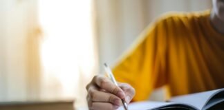 selective focus photo of person writing