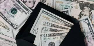 set of black opened envelope and cash dollars