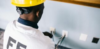 an electrician repairing the ac power plugs and sockets