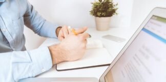 person holding pen and notebook