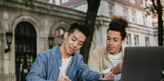 positive multiethnic students doing homework in team