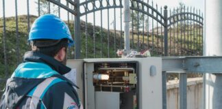 an electrician inspecting a fuse box
