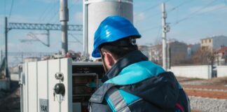 an electrician inspecting a fuse box