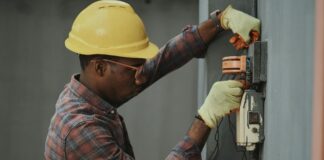 an electrician repairing a fuse box