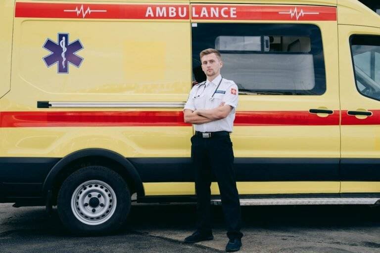 a paramedic standing in front of the ambulance