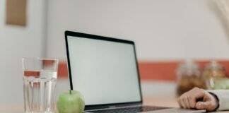 green apple fruit beside black tablet computer on brown wooden table