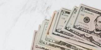 different dollar bills on marble surface