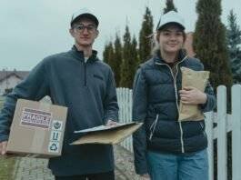 a man and a woman holding delivery packages